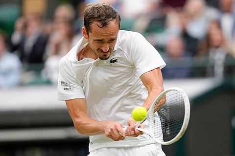 Daniil Medvedev plays a backhand return to Grigor Dimitrov